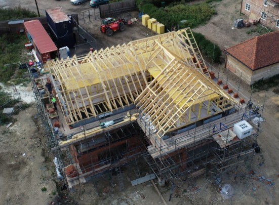 An ariel shot of a  trussed roof being constructed.