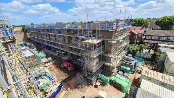 A view of the scaffolding around a block new building showing the loading bays.