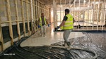 Flow screed being laid on black DPM.
