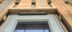 A slot over a window for ventilation. 